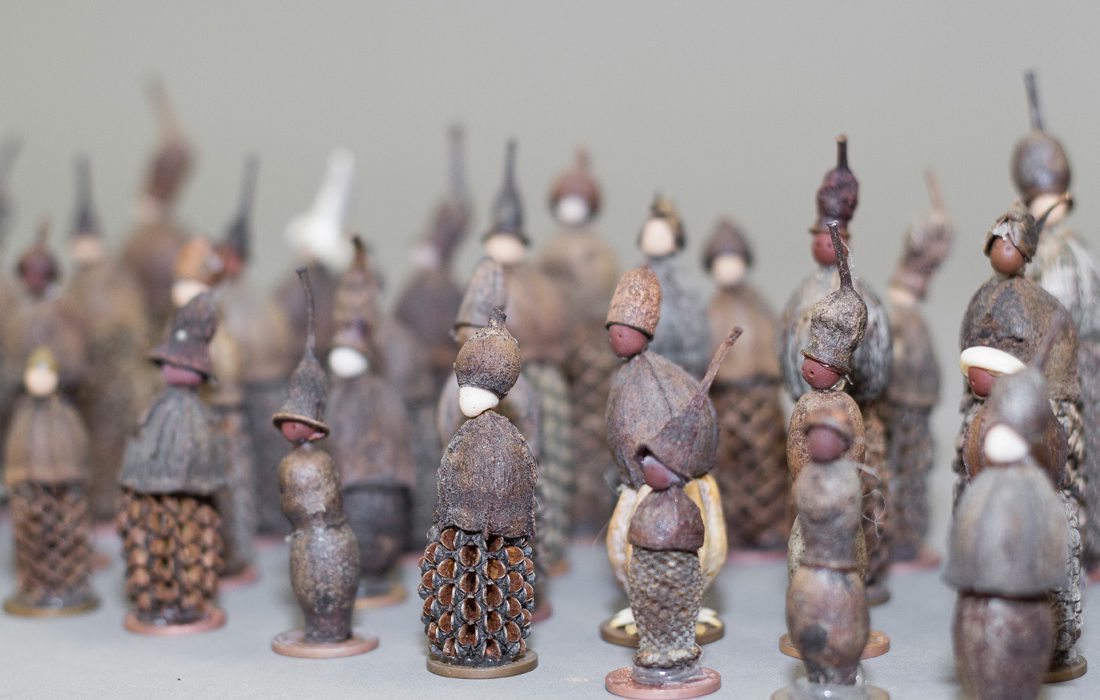 Joanna Simpson_Good Luck Gum Nut Folk detail_Cred Oana Damir Lots of tiny figures standing in rows made from nuts and seeds.