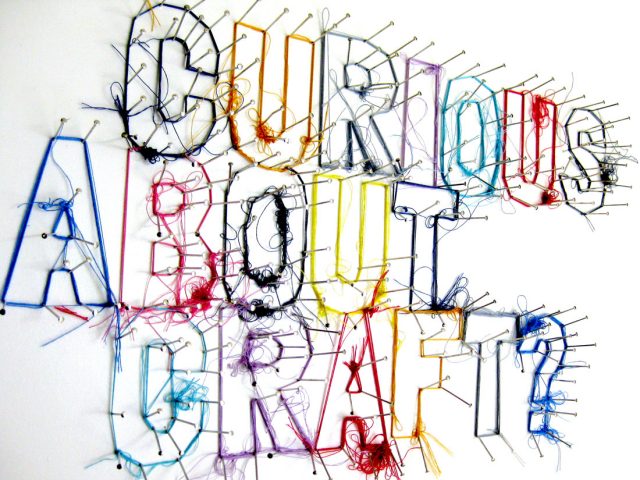 curious about craft is spelled out by pins wrapped in thread.