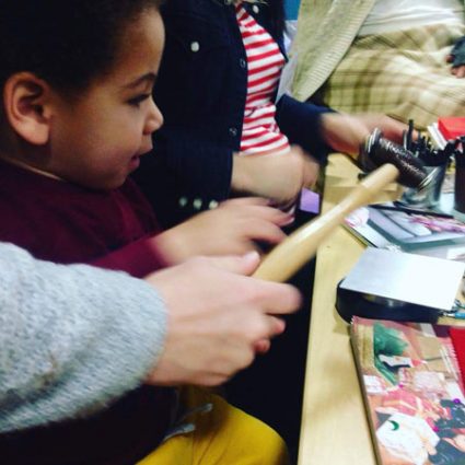 6 A very young child reaches for a hammer to work with metal.