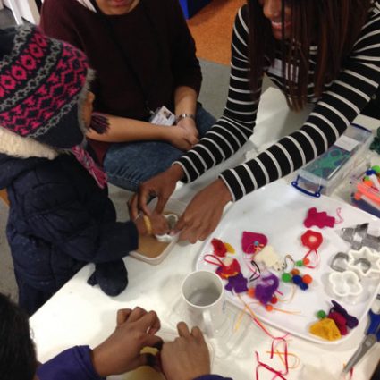 8 An artist helps a child design with plastic pieces.