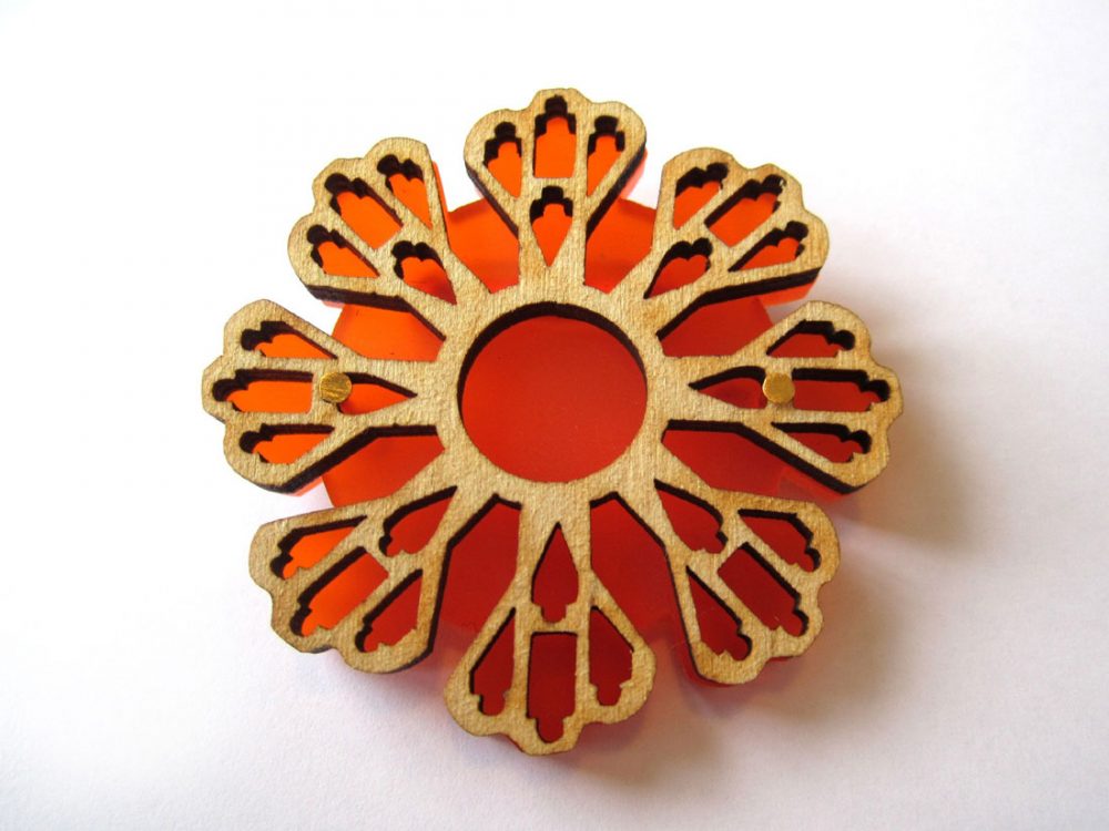 Large lasercut orange brooch made by Shelanu.