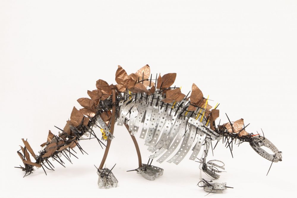 A model of a dinosaur made from pieces of metal.