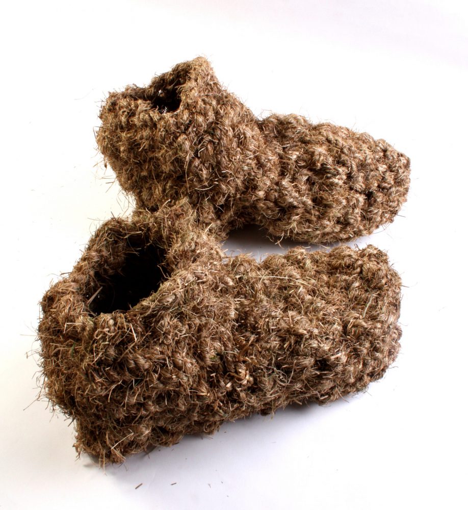 A pair of boots made from grass.