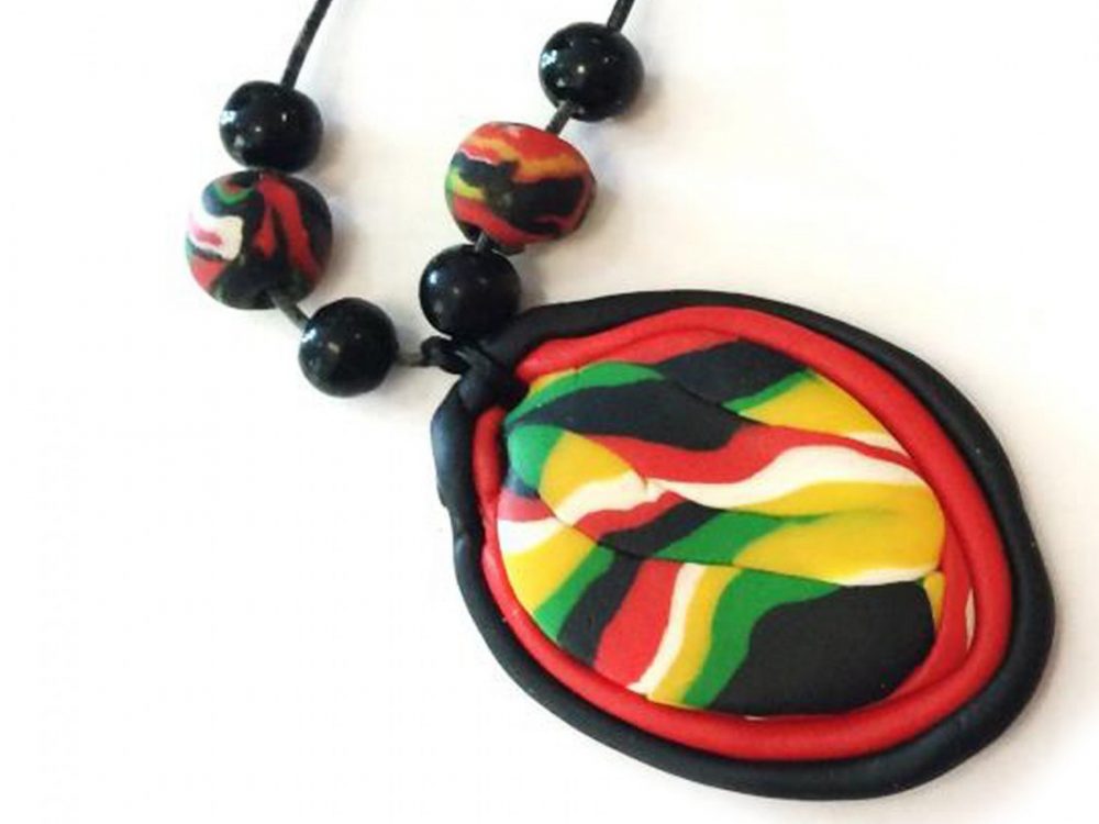 A pendant made from brightly coloured oven baked clay.