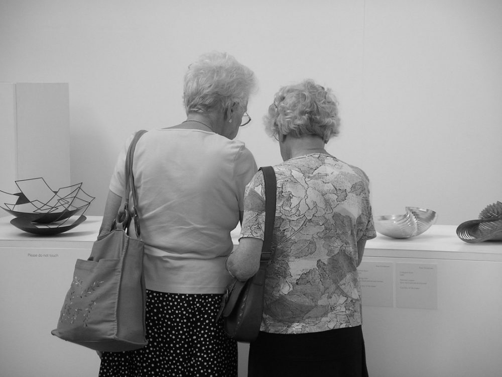 Two women look around an exhibition.
