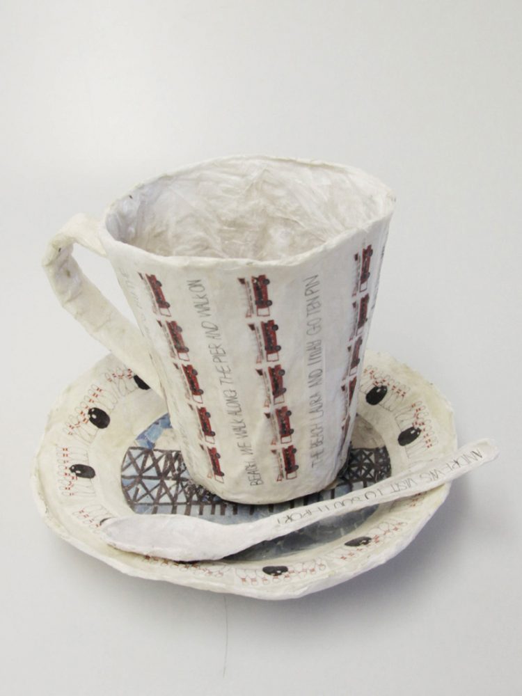 A teacup, saucer and spoon made from paper.