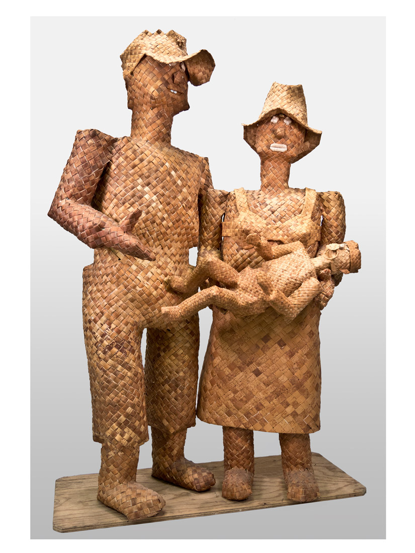 Three figurines, two adults holding a baby, woven from strips of wood.