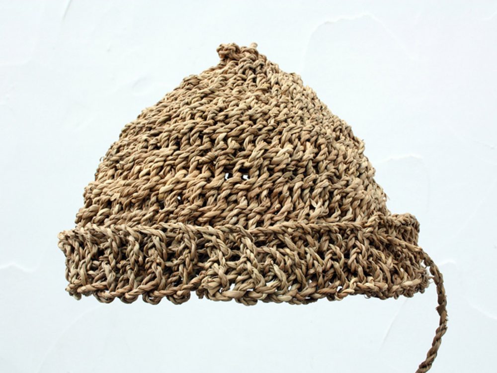 A hat woven from brown straw string.