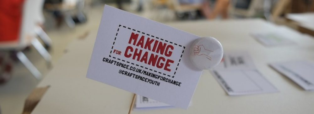 Making for Change card and small badge with drawn stitch fist logo