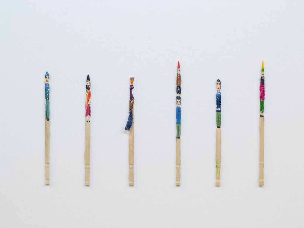 Six wooden pencils with various characters painted on to them in bright colours.