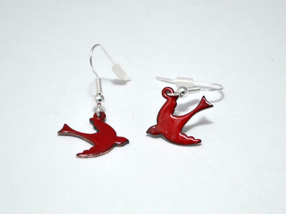 close up of pair of bright red enamel swallow bird earrings