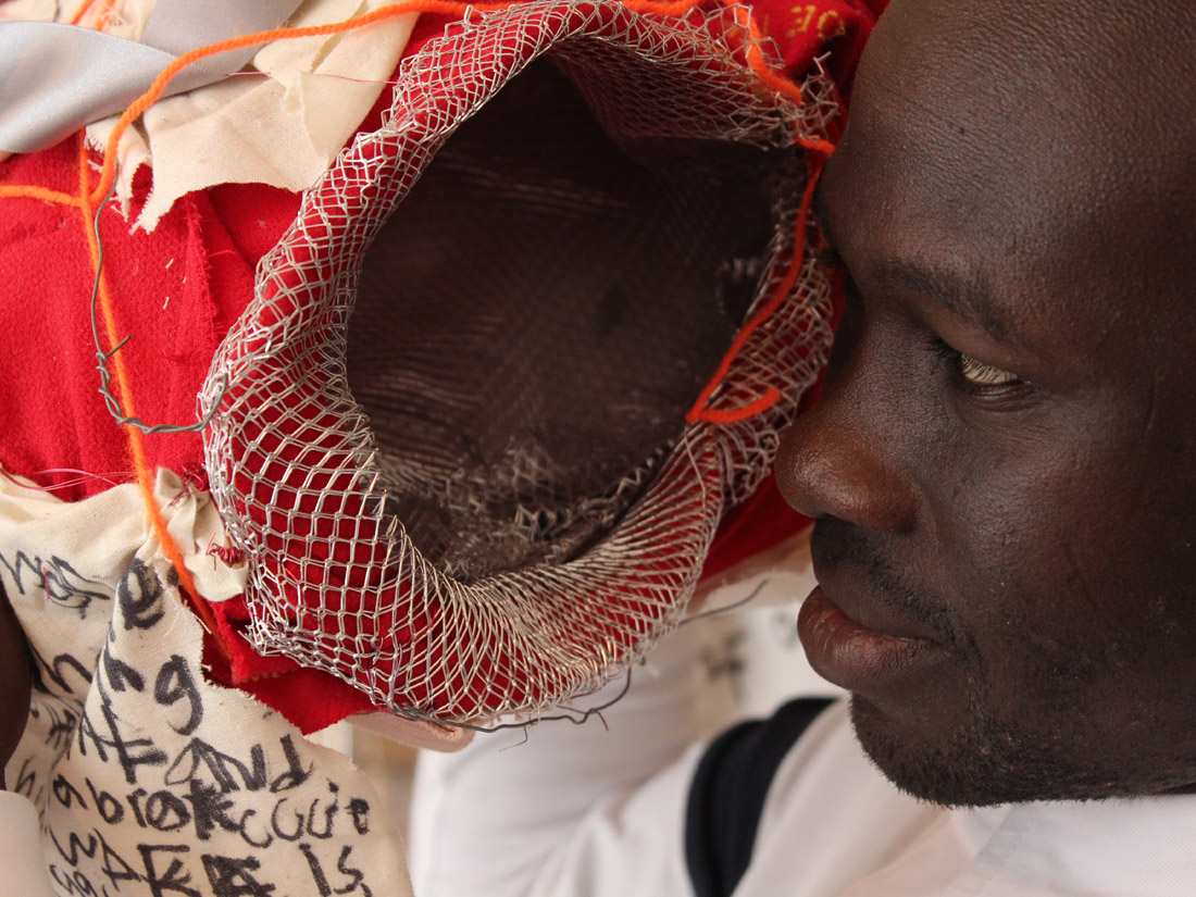 A close up on Andrew looking into one of the 'pockets' of his textile works.