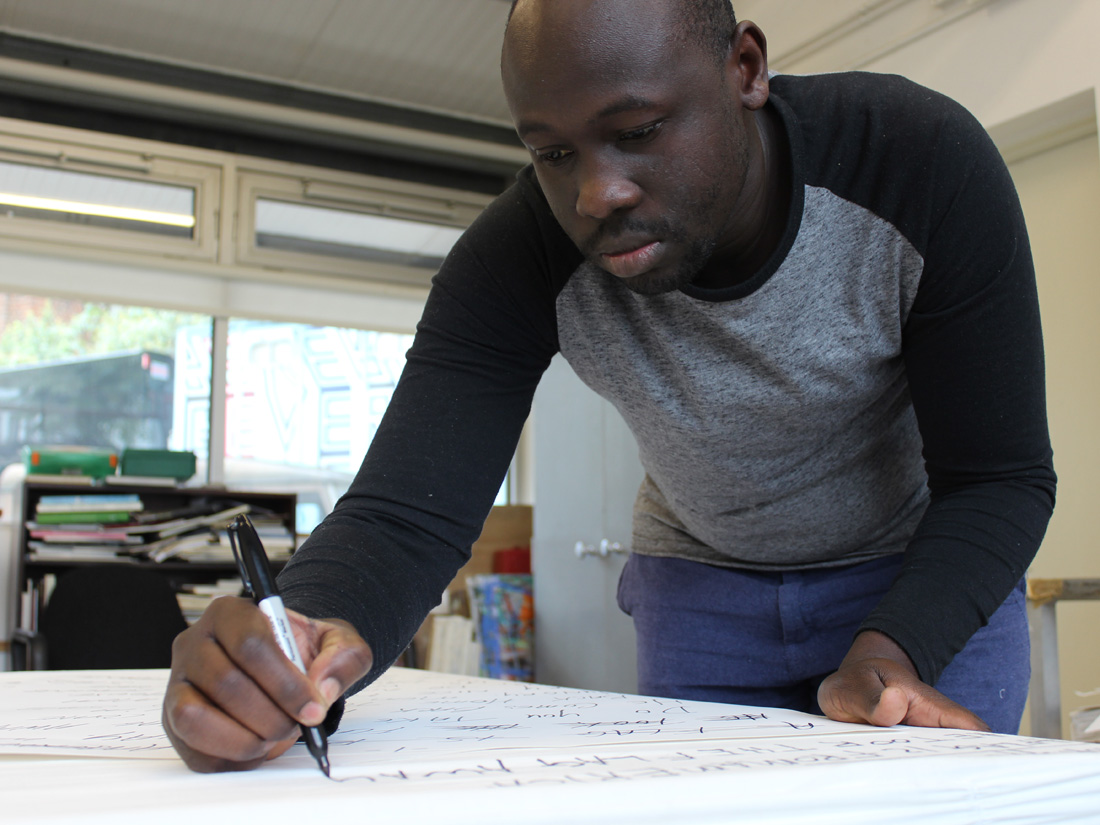 Andrew concentrating writing out letters for one of his book works