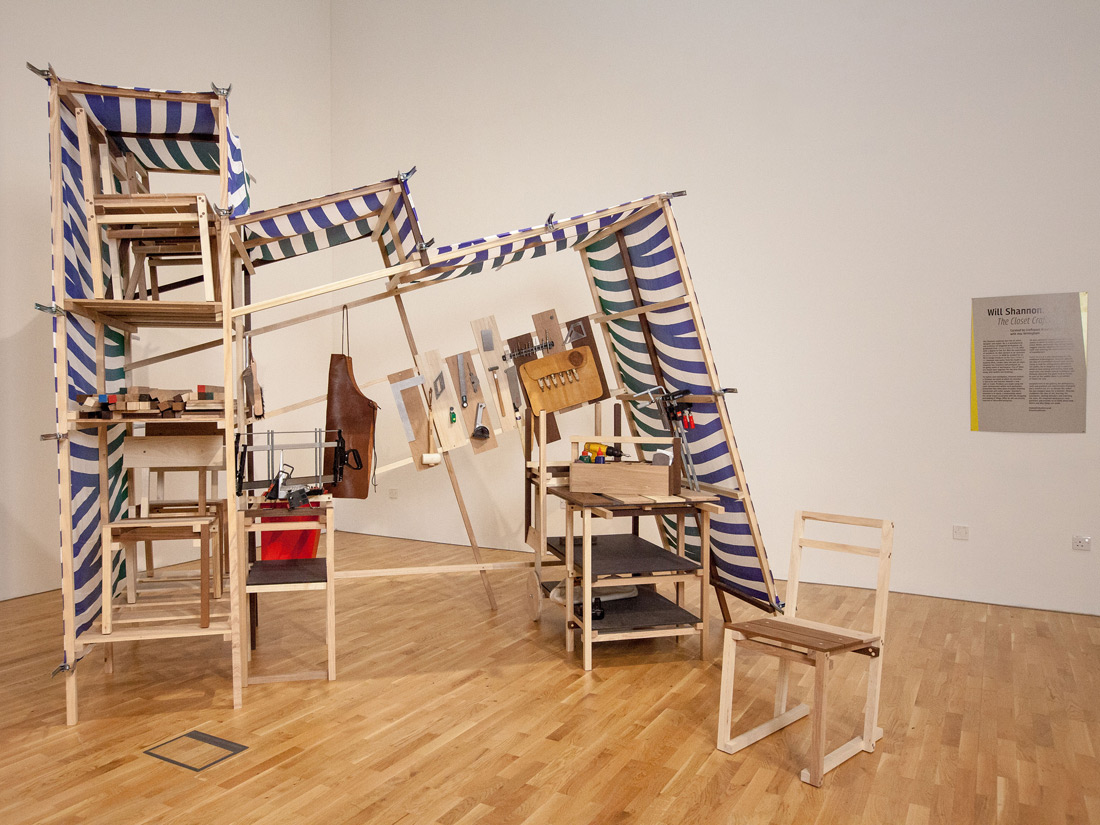 A exhibit in a gallery which looks like a makeshift market stall.