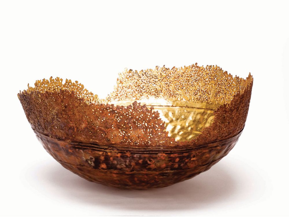 A metal bowl with delicate edges.