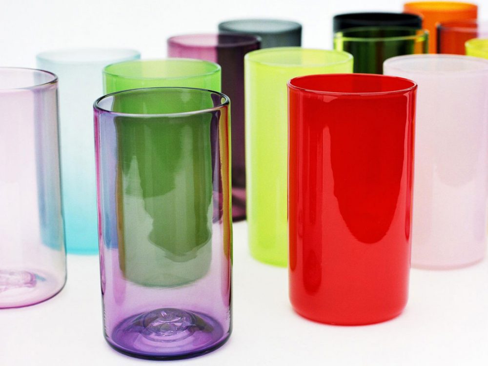 Tall glass beakers of various colours and opacities.