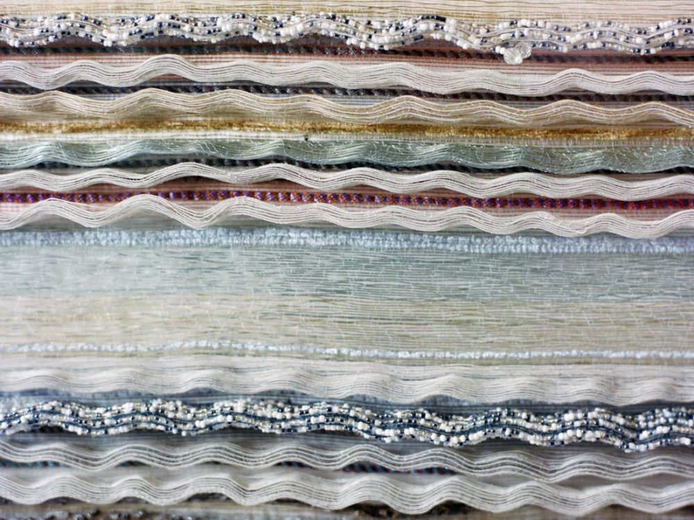 Detail of the final woven cloth, using neutral colours and embellishments.