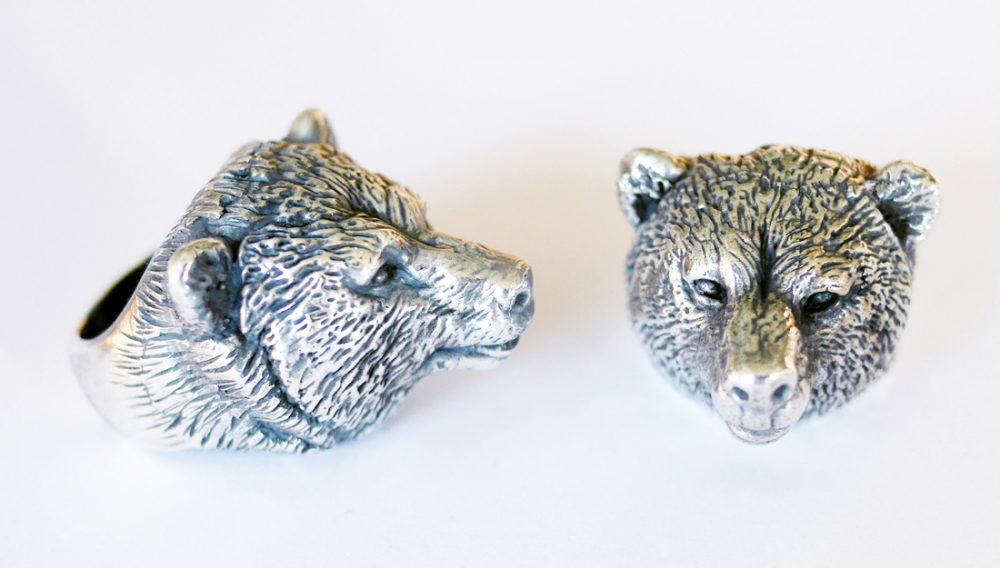 silver rings decorated with detailed heads of bears.