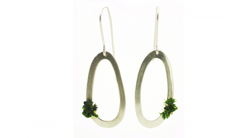 SIlver circle earrings with green mosslike decoration.