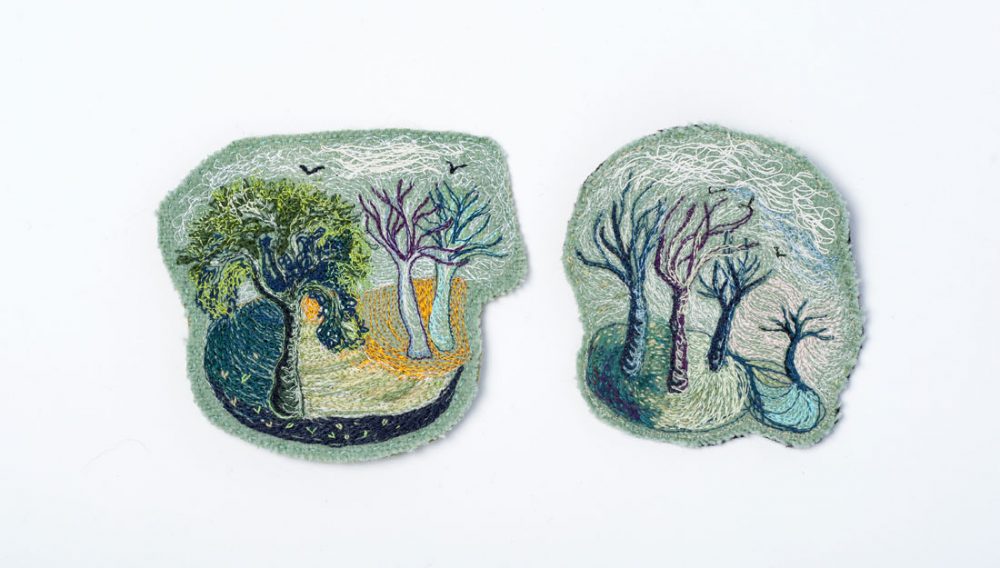 Two textile patches with various coloured threads stitched into them to create tree and nature scenes.