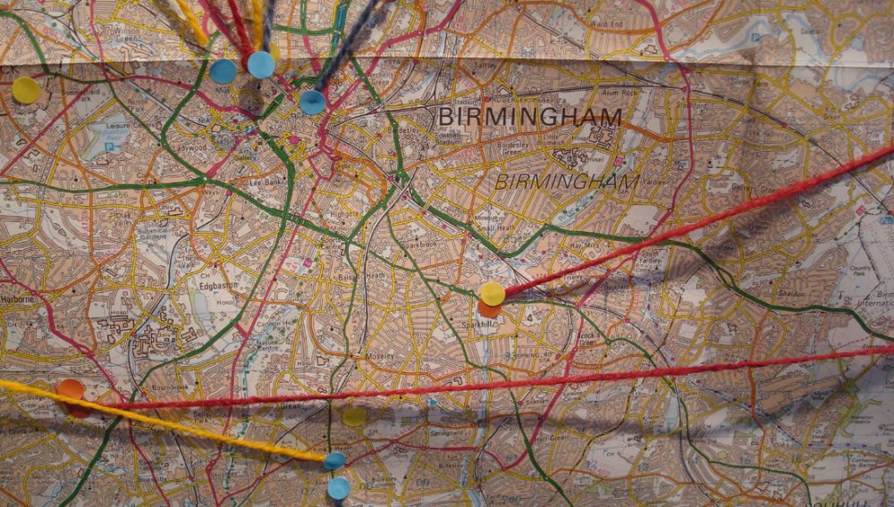 A map of Birmingham with various pins and stickers at locations.