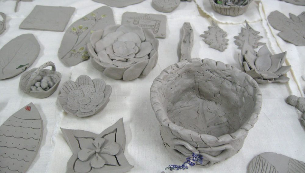 Various pieces made out of clay sit on a tabletop.