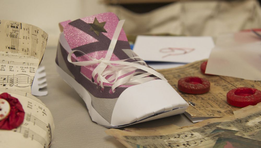 A small shoe made out of paper.