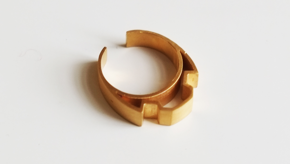a gold ring with a very geometric design