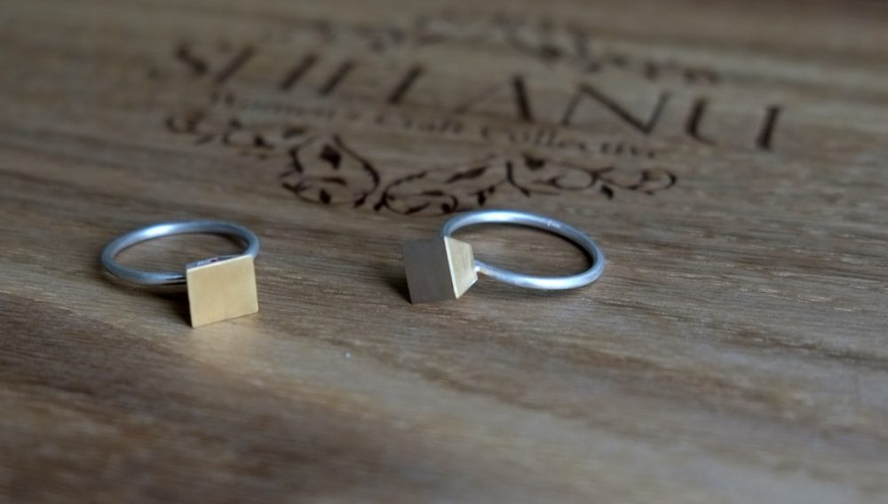 2 Shelanu Interlocking Stories range rings in part gold and silver, simple diamond and square stud design.
