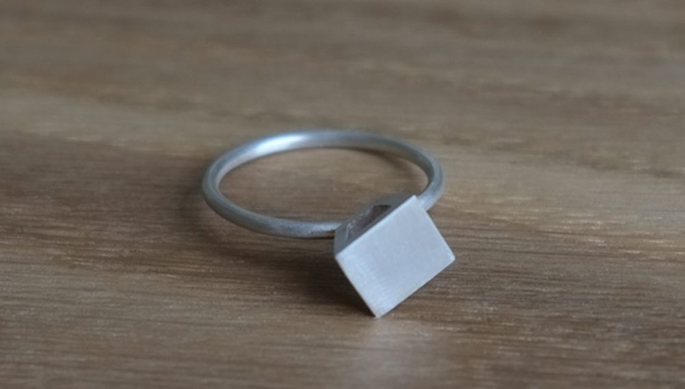 Shelanu Interlocking Stories range ring in silver, simple diamond stud design.
