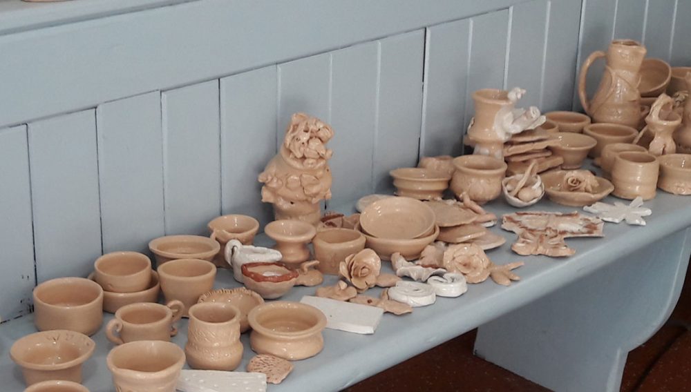 A display of clay items made during workshops.