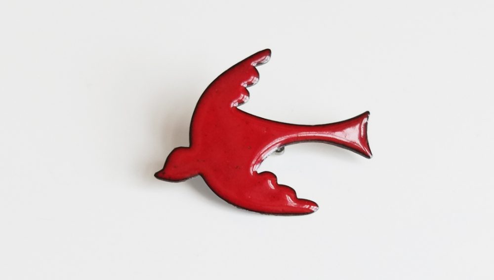 red enameled bird brooch. simple in design.