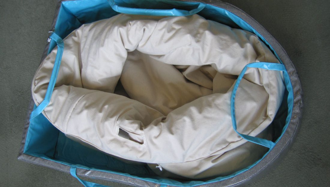 a boat shape made form foam with handles so it can be pulled around. inside is another 'boat' like a duvet, soft and padded, big enough for a small child to sit inside and play.