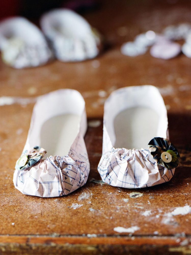 Shoes made out of paper and buttons.