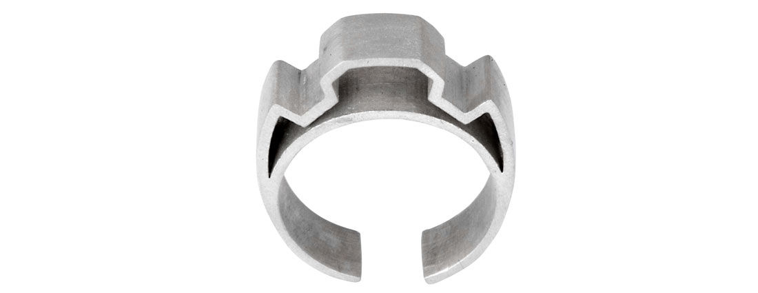 A chunky silver ring with a strong geometric shape.