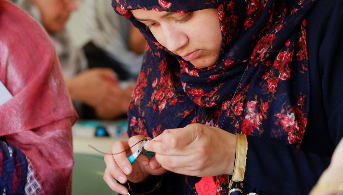 A participant concentrates on the fixings for her jewellery