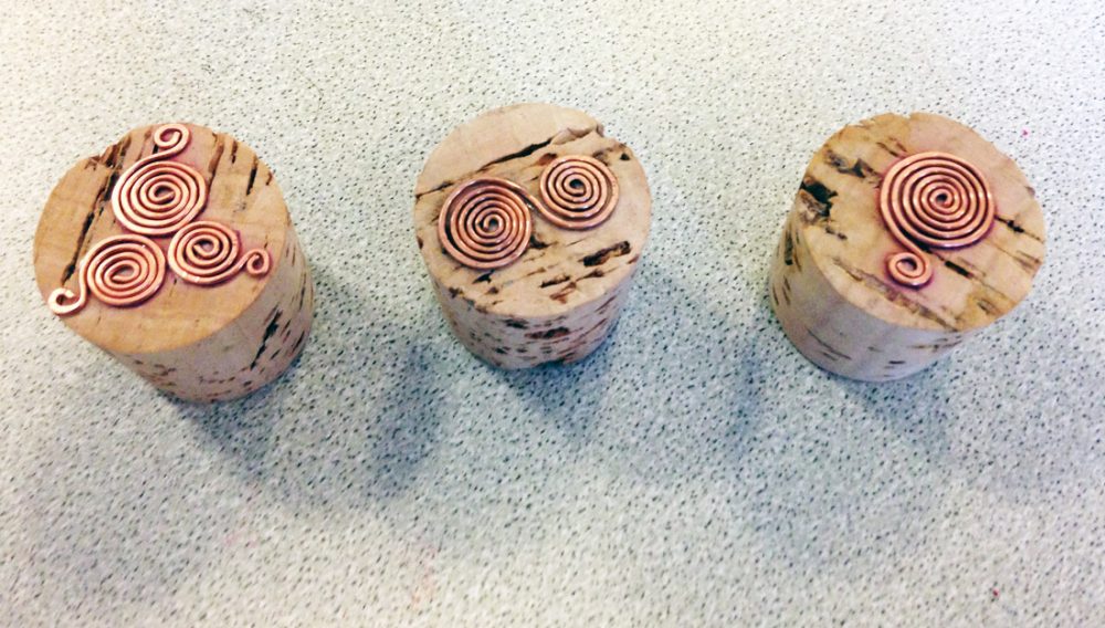 Stamps made from cork and metal - the metal has been manipulated into swirl shapes.