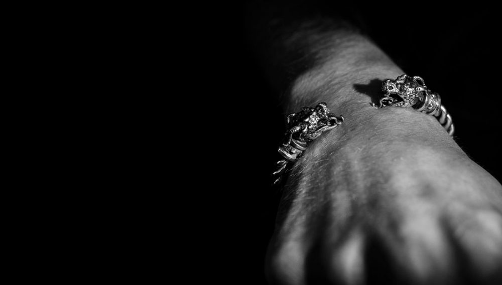 black and white photograph of silver dragon cuff