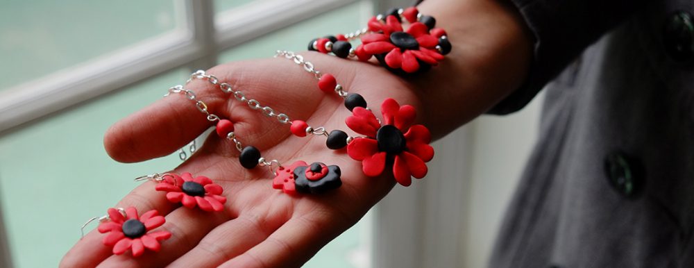 a women displays jewellery she has made on the her hand.