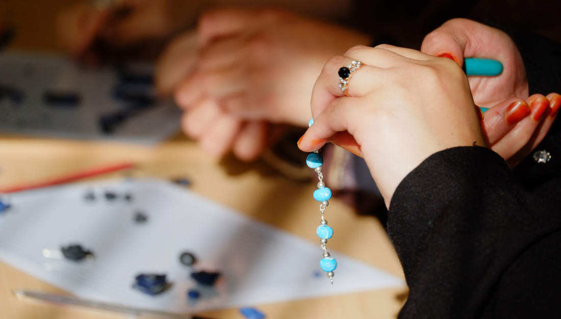 hands using pliers to fix fimo jewellery bracelet