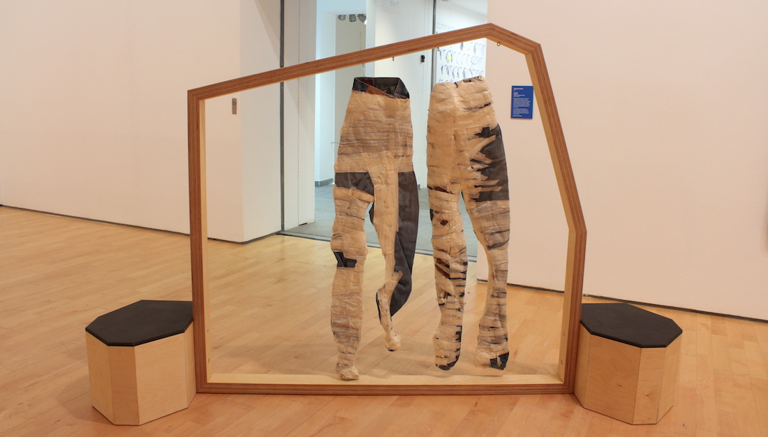 jeans with tape wrapped round them displayed in the gallery