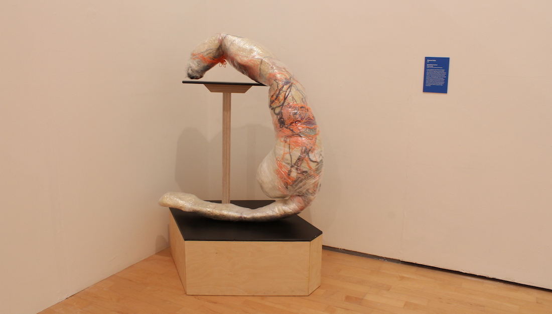 textile and cling film sculpture displayed on plinth in gallery