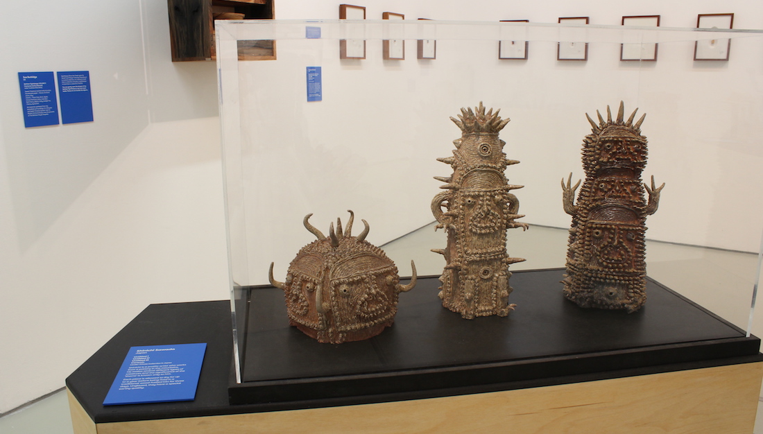 three sawada ceramic sculptures in exhibition case on plinth
