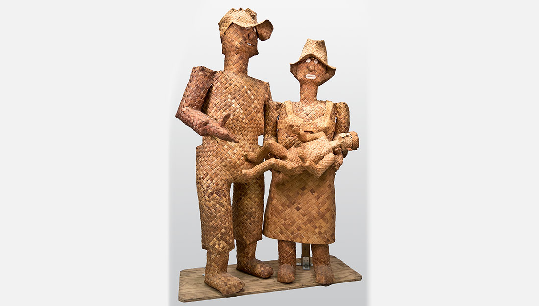 woven sculpture of man, woman holding a child