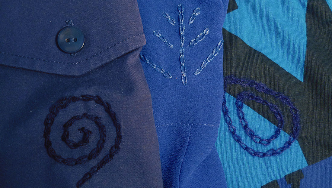 embroidery designs in blue thread on blue clothes.