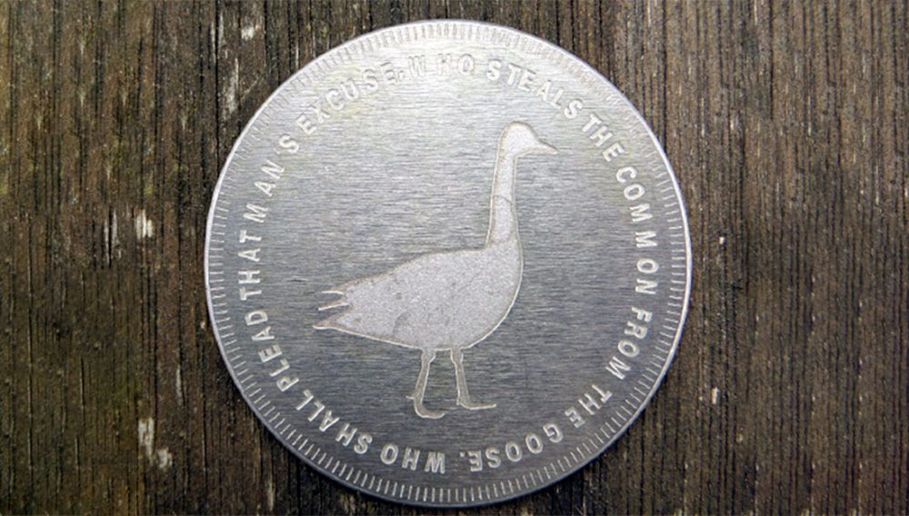 A silver token, like a big coin.
