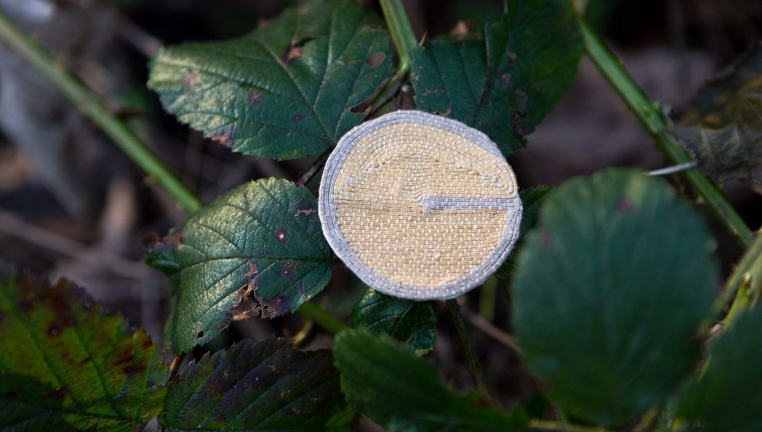 A small embroidered circular token