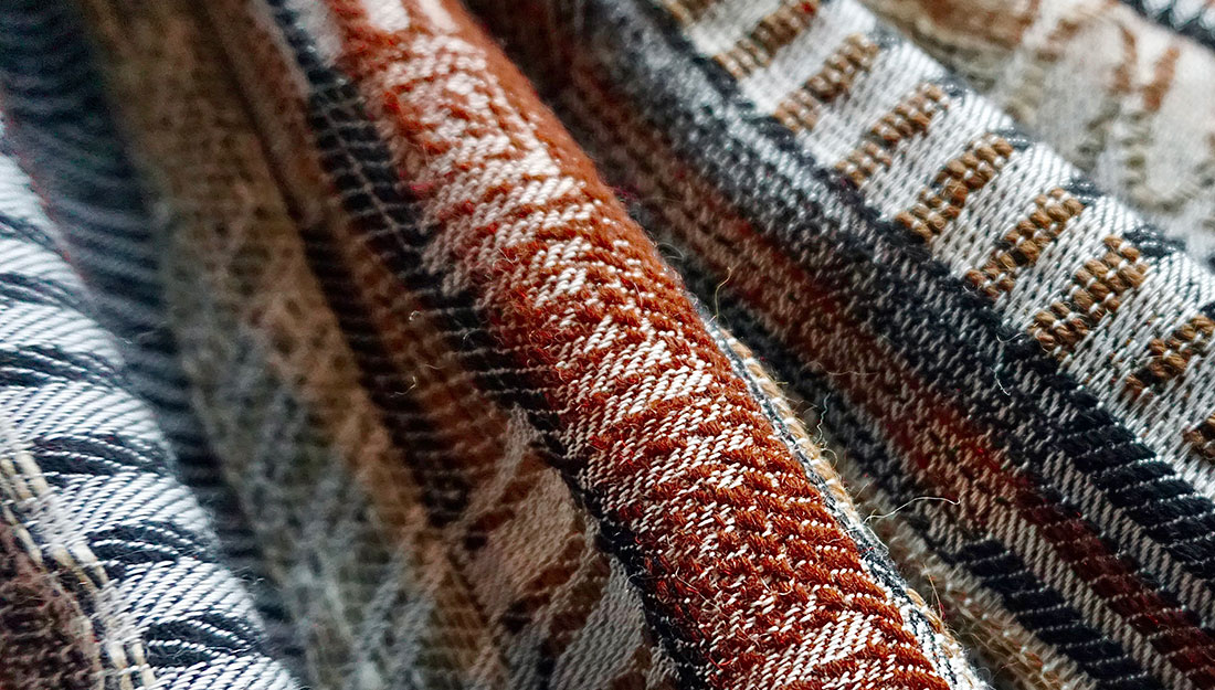 Woven fabric with a geometric and natural coloured design.