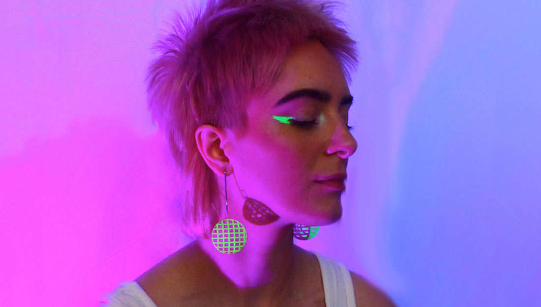A model wears geometric neon jewellery.