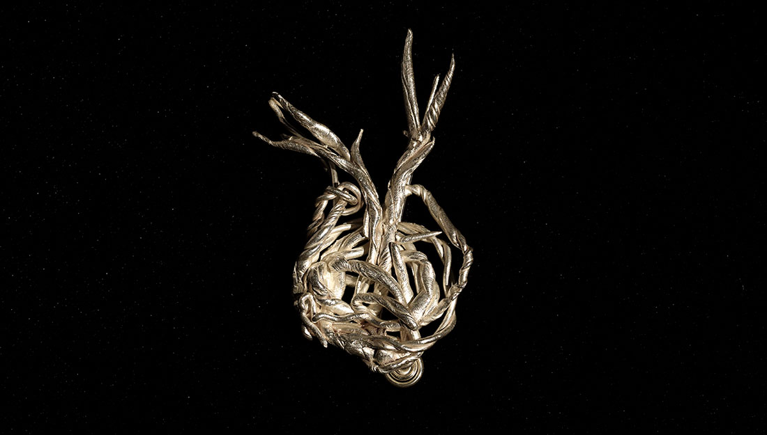 An abtract metal form made of twisted branchlike forms.